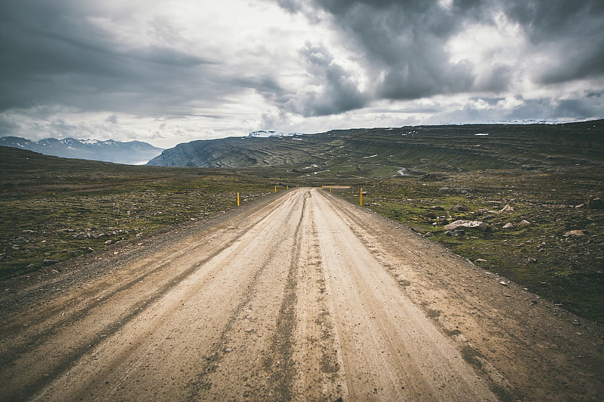Dramatic Gravel Road Through Highland Landscape