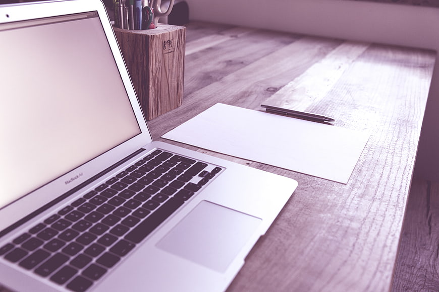 Minimalist Workspace with Laptop and Notebook on Wooden Desk
