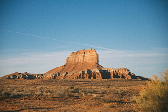 Red Rock Butte in Desert Landscape Under Blue Sky