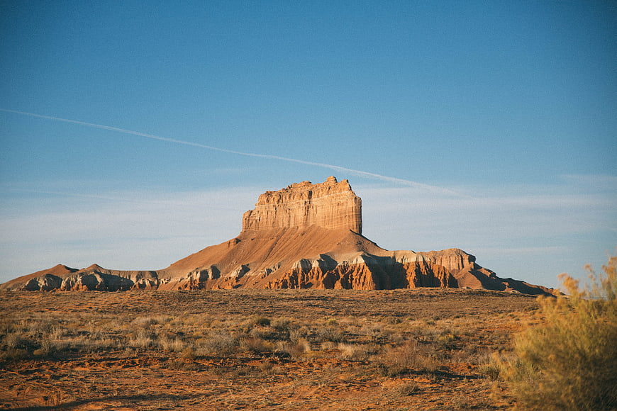 Red Rock Butte in Desert Landscape Under Blue Sky