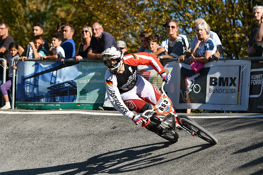 BMX Cyclist Racing on Track with Spectators