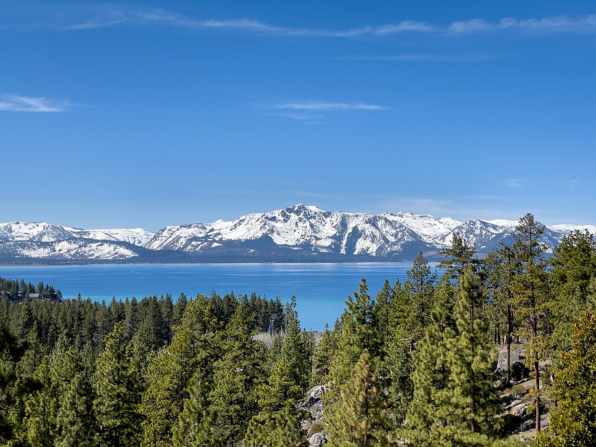 Scenic View of Lake Tahoe with Snow-Capped Mountains and Pine Forest