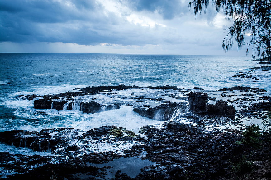 Dramatic Blue Ocean Waves Crashing on Rocky Shoreline