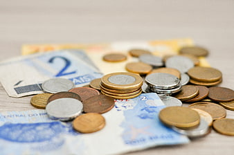 Brazilian Real Coins and Banknotes on Wooden Table