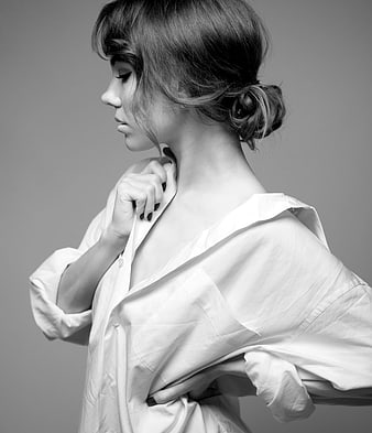 Black and white portrait of woman in white shirt