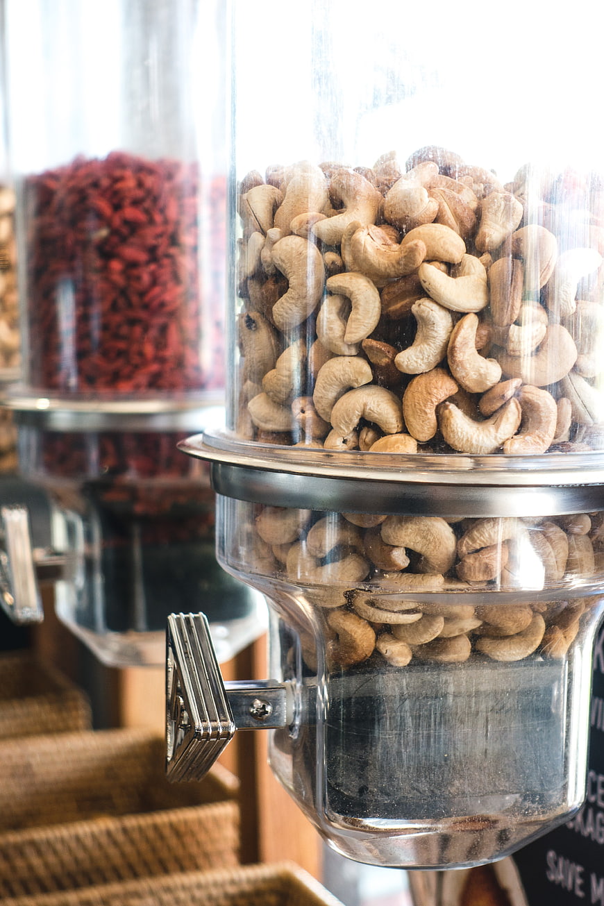 Cashew nuts in a glass dispenser at a health food store