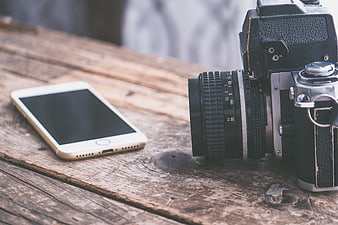 Vintage Film Camera and Smartphone on Rustic Wooden Table