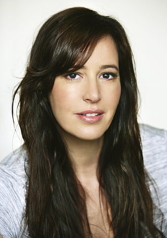Portrait of a confident woman with long dark hair