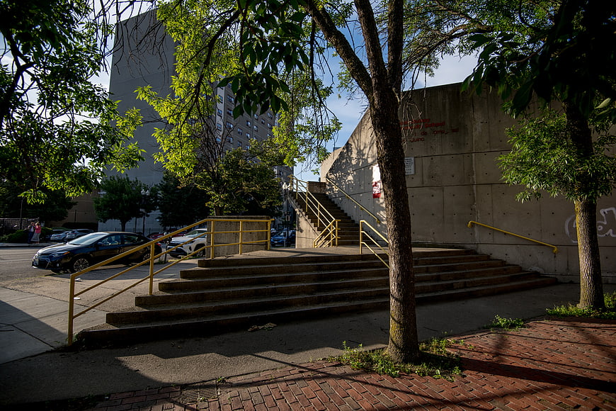 Urban Concrete Staircase with Yellow Rails and Trees