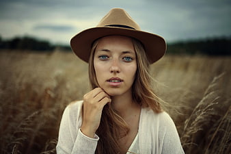Portrait of Young Woman in Fedora Hat in Wheat Field