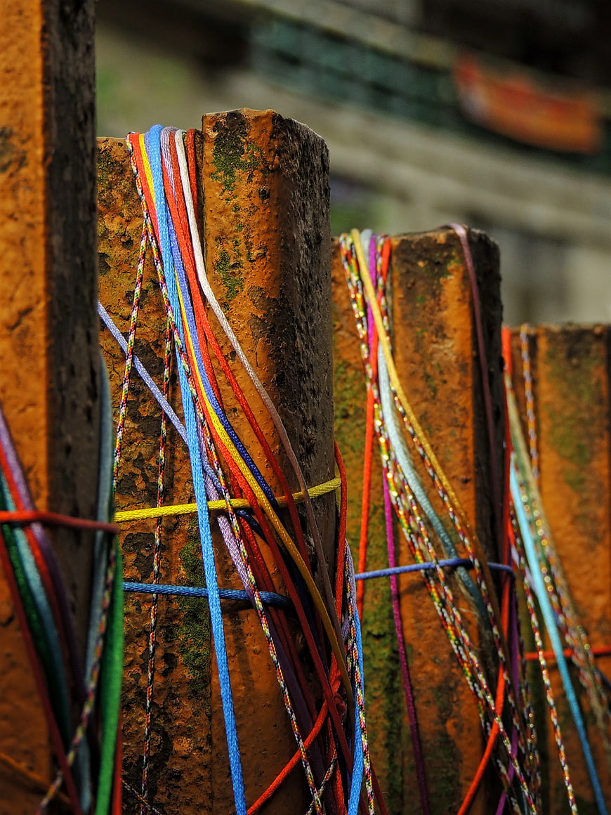 Colorful Rubber Bands on Rusty Metal Fence