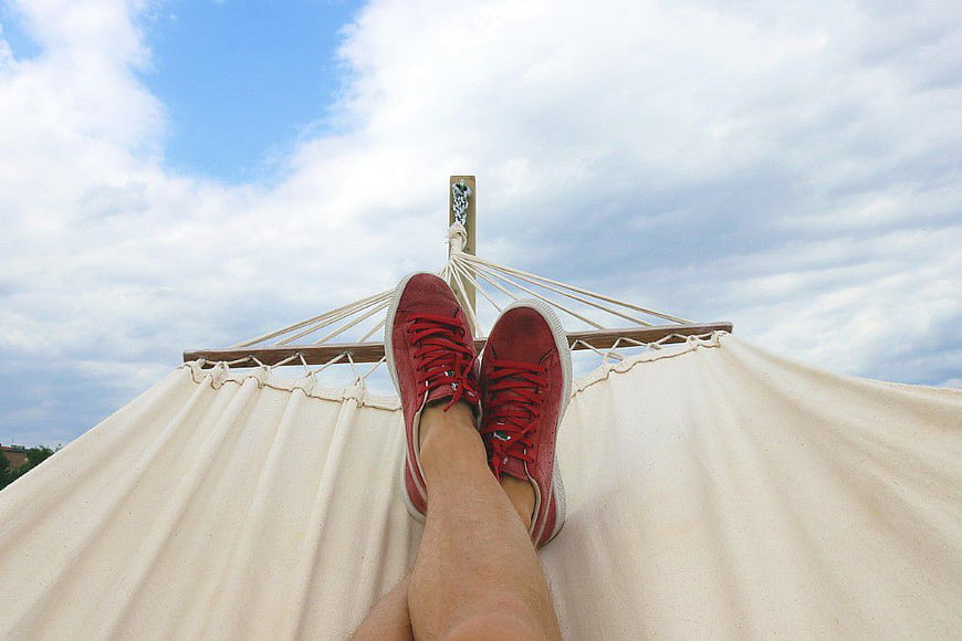 Red Sneakers on Hammock Against Blue Sky