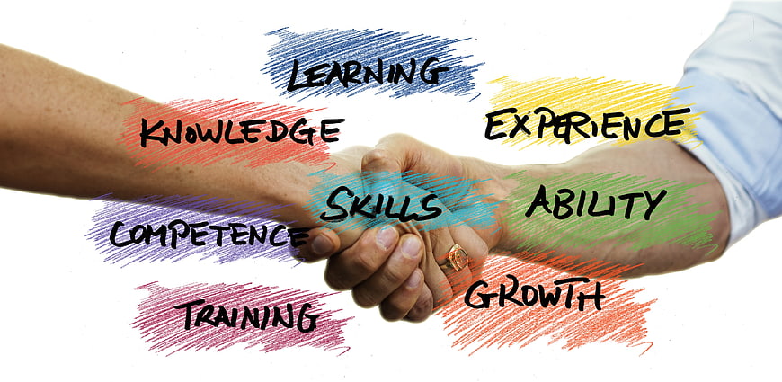 Handshake with professional development keywords like skills and growth
