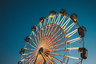 Illuminated Ferris Wheel Against Deep Blue Night Sky