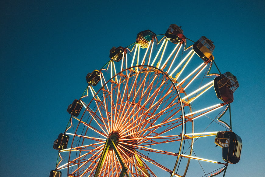 Illuminated Ferris Wheel Against Deep Blue Night Sky