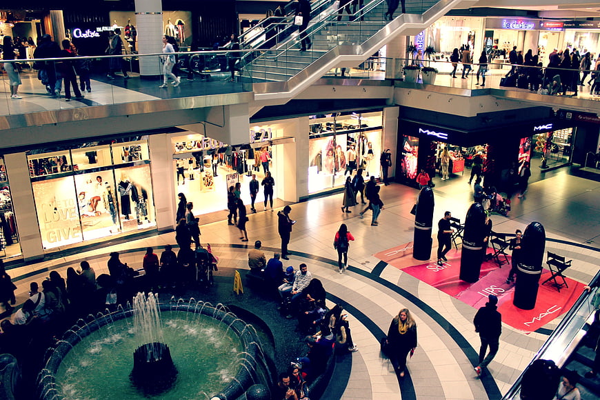 High Angle View of Busy Shopping Mall Interior with Fountain