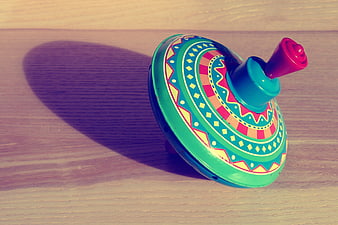 Colorful Vintage Spinning Top Toy on Wooden Surface