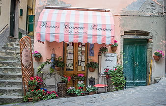 Charming Italian Apartment Entrance with Pink Striped Awning