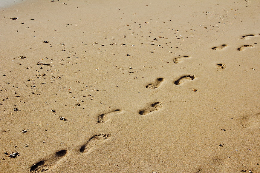 Footprints in Sand on a Sunny Beach