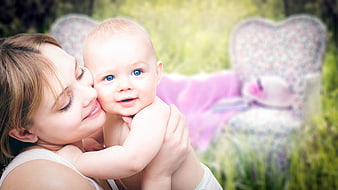 Mother Holding Smiling Baby In Garden With Heart Bench