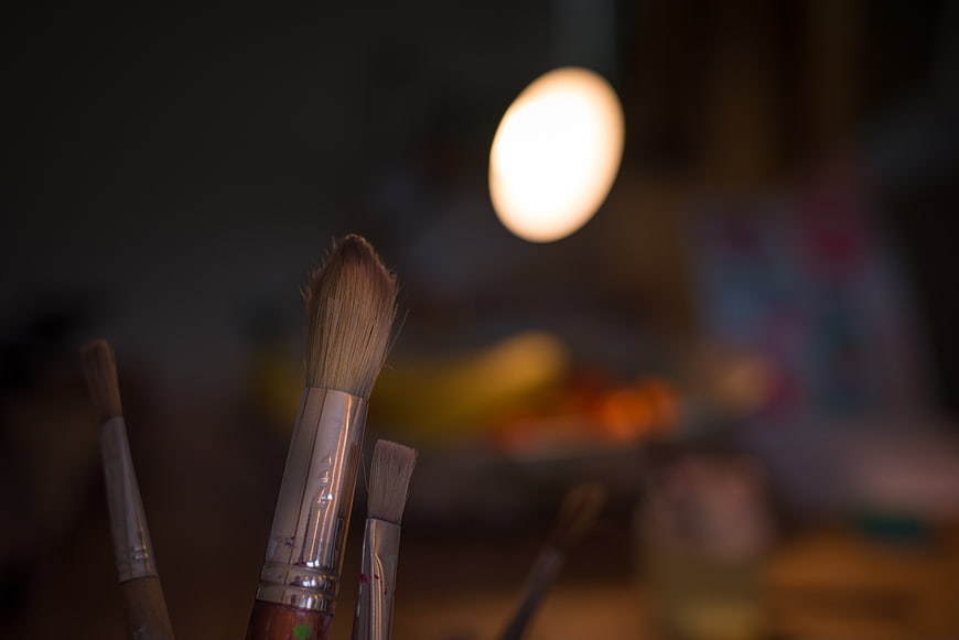 Close-up of paintbrushes in an art studio with bokeh background