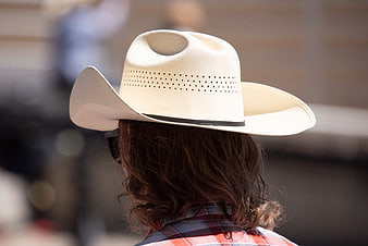 Rear View of Person Wearing White Cowboy Hat and Plaid Shirt