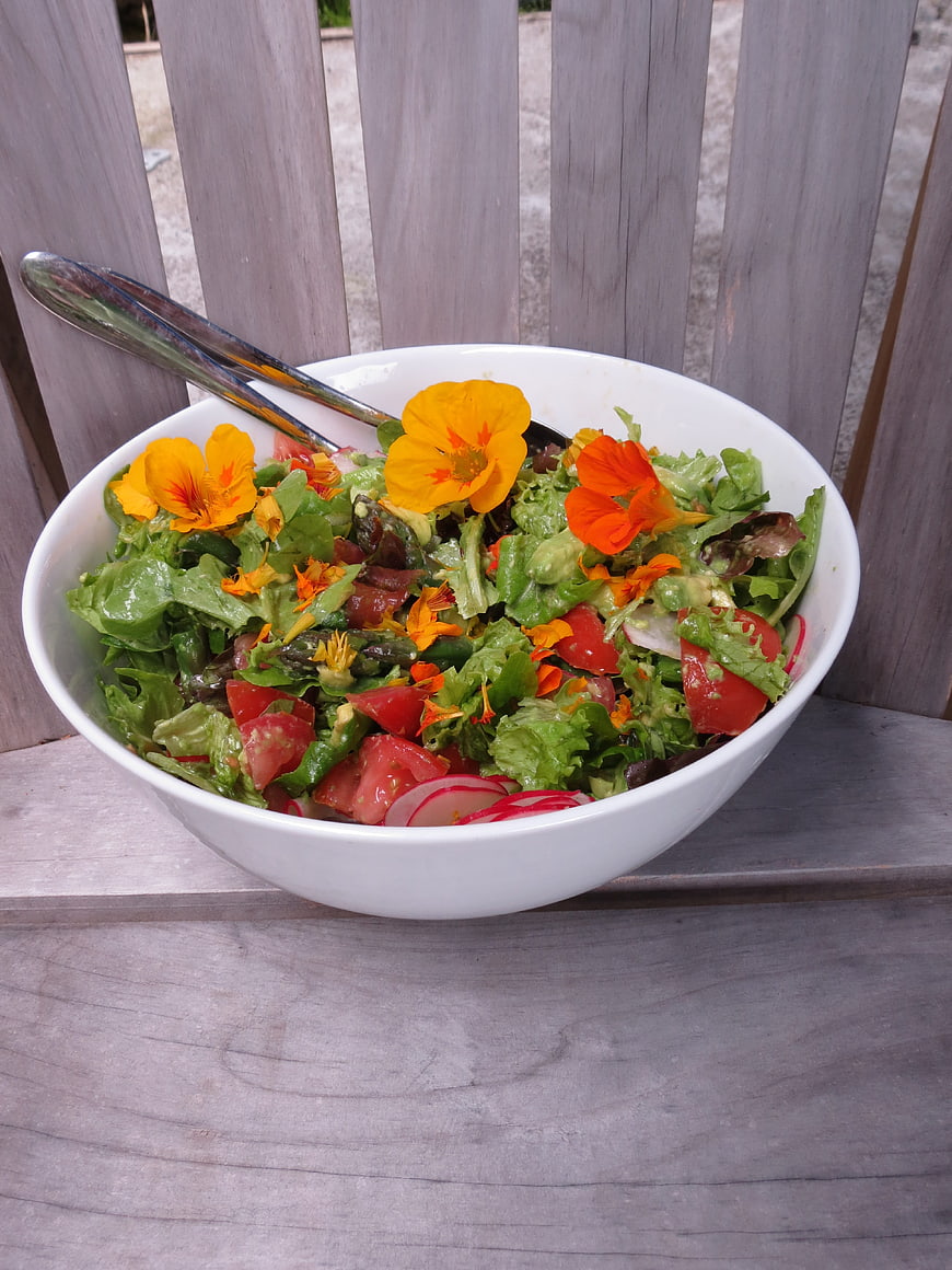 Fresh Garden Salad with Edible Flowers in White Bowl