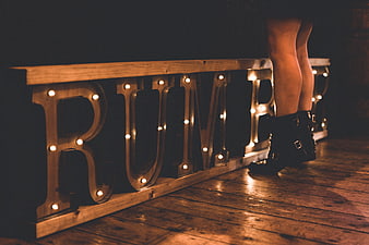Woman's legs in boots next to BUMP marquee sign