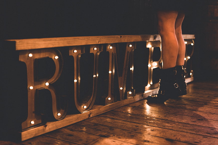 Woman's legs in boots next to BUMP marquee sign