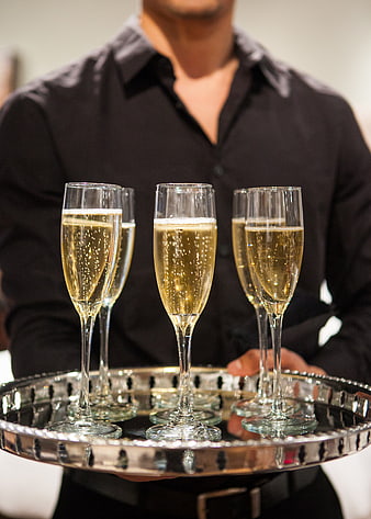 Waiter serving champagne on silver tray