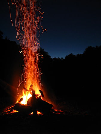 Bonfire with sparks flying into the night sky