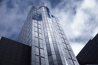 Modern Glass Skyscraper Facade Against Cloudy Sky