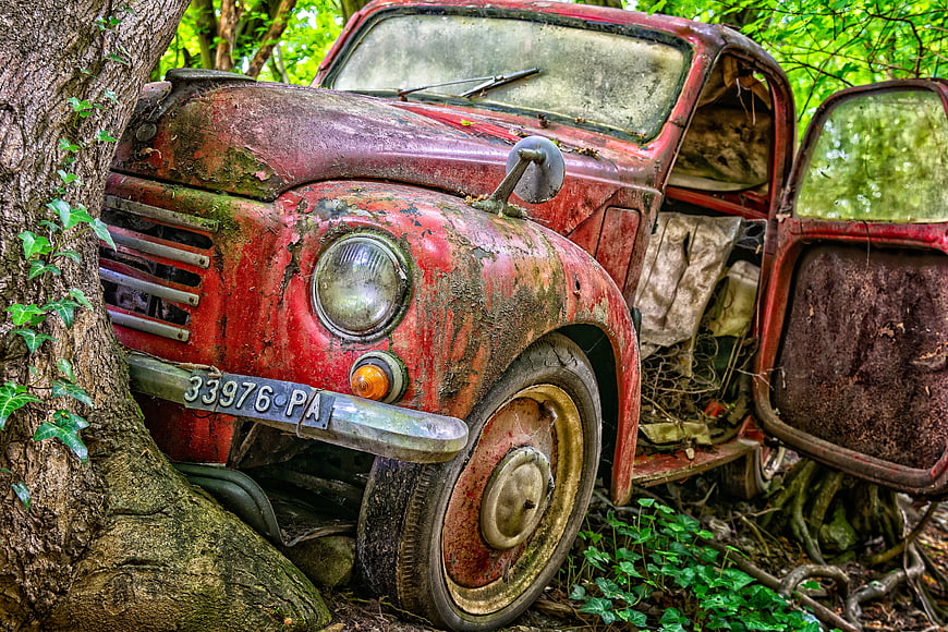 Abandoned Rusty Red Vintage Car in Forest