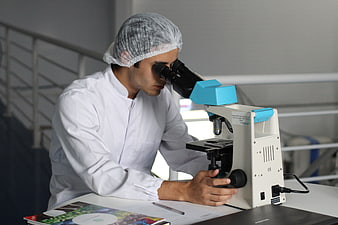 Scientist using microscope in laboratory