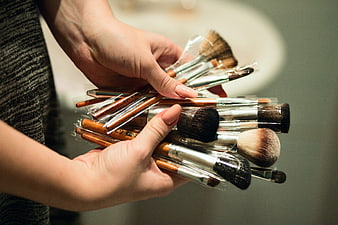 Woman holding new makeup brushes in hands