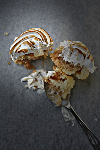 Broken Caramel Cupcake with Meringue Topping on Gray Background