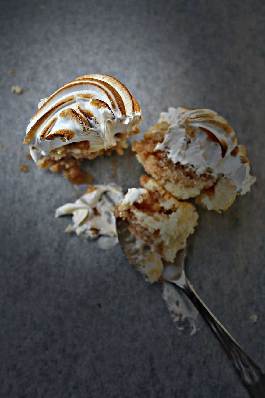 Broken Caramel Cupcake with Meringue Topping on Gray Background
