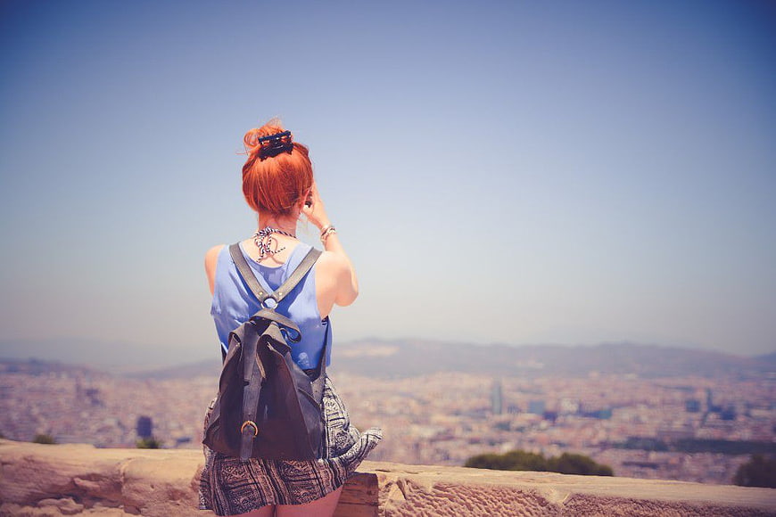 Woman with Red Hair Looking at City Panorama