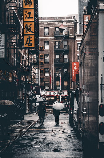 Rainy Chinatown Street with Umbrellas and Chinese Signs