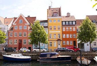 Colorful historic houses and boats along a canal in Copenhagen, Denmark