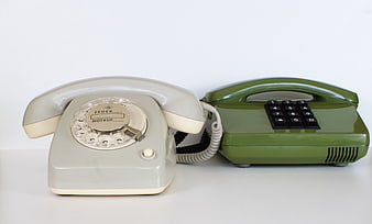 Vintage Rotary and Push-Button Telephones on White Background