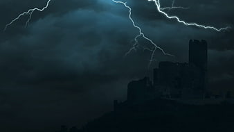 Dramatic Lightning Storm Over Dark Castle Ruins at Night