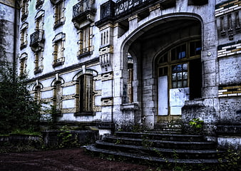Abandoned Hotel Facade With Overgrown Steps And Weathered Architecture