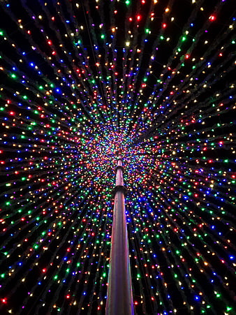 Colorful Christmas Lights Radiating from Central Pole at Night