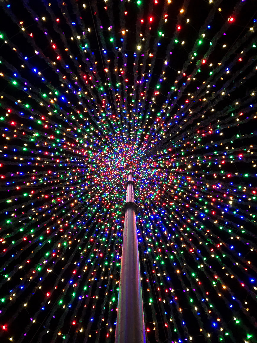 Colorful Christmas Lights Radiating from Central Pole at Night