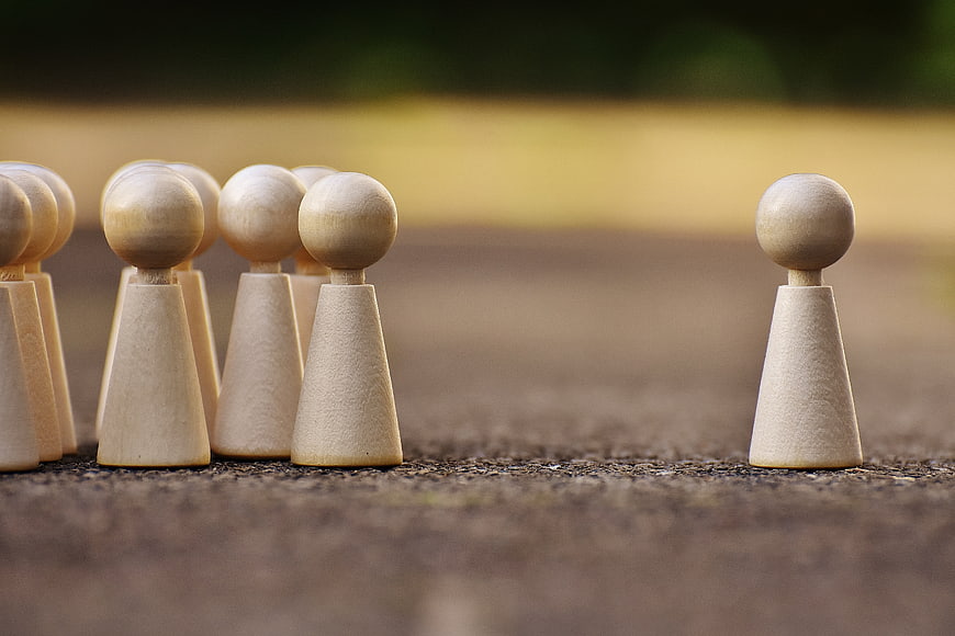 Wooden game pieces symbolizing leadership and teamwork