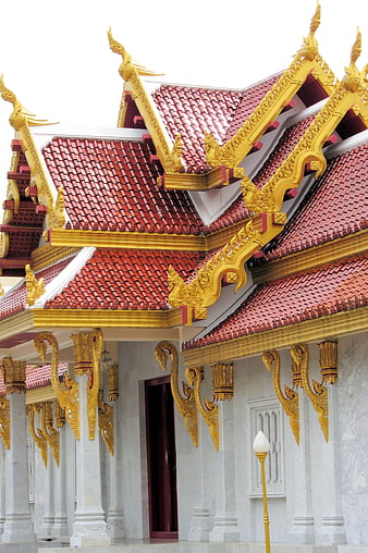 Golden Thai Temple Roof with Red Tiles and Intricate Details