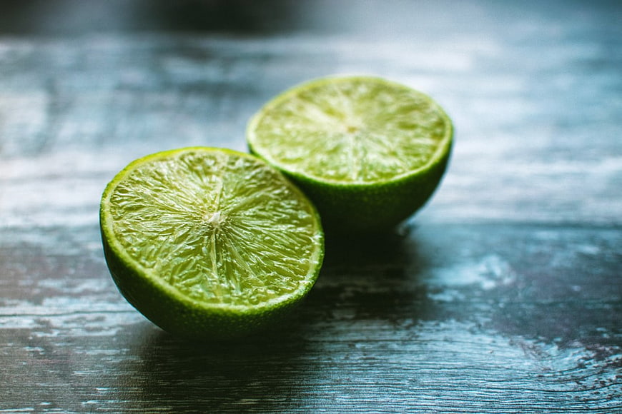 Fresh Sliced Lime on Rustic Blue Wooden Table