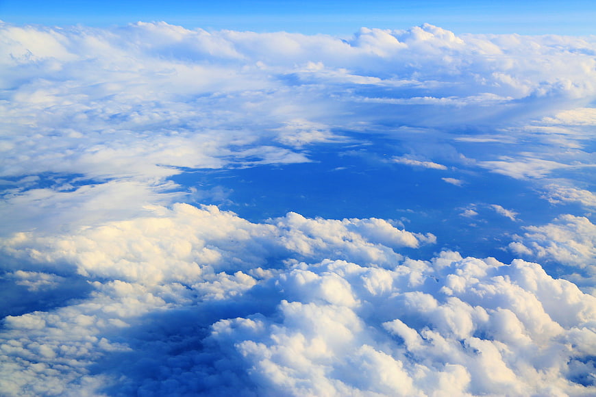 Aerial View of Fluffy White Clouds Against Blue Sky