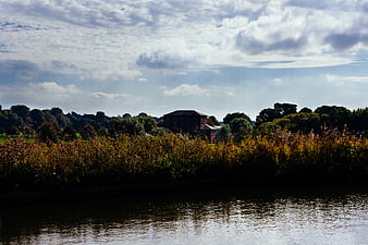 Riverside landscape with house and autumn foliage